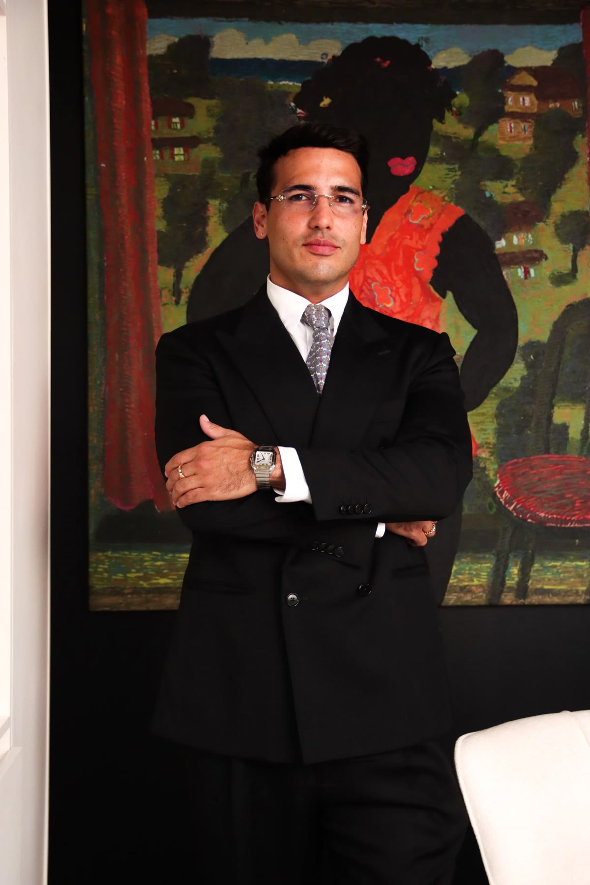 Herman Duarte, founder of Simple Legal Consulting, in front of a painting from the office collection